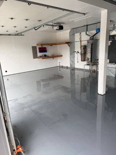 Freshly coated gray epoxy garage floor with a high-gloss finish