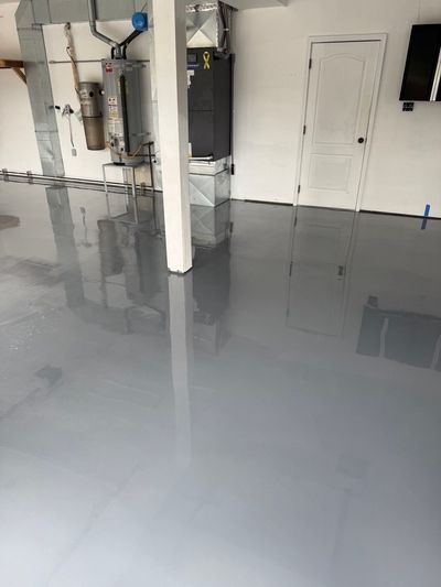 Close view of a smooth gray epoxy garage floor near the entry door